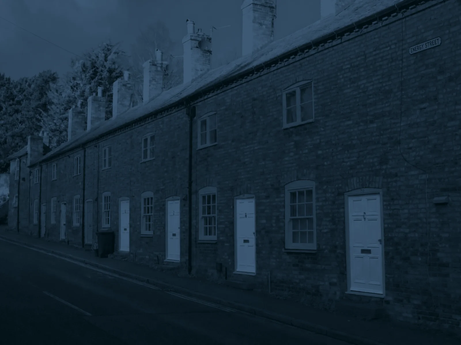 Terrace of red-brick rented houses with brightly painted front doors