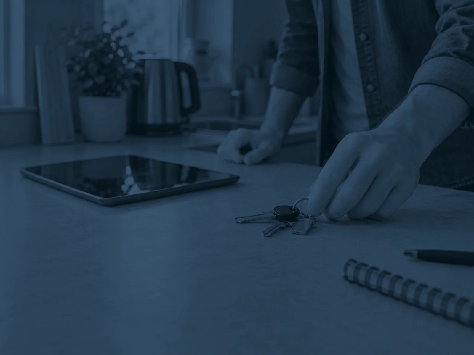 House keys and a tablet on a kitchen worktop in a rented flat