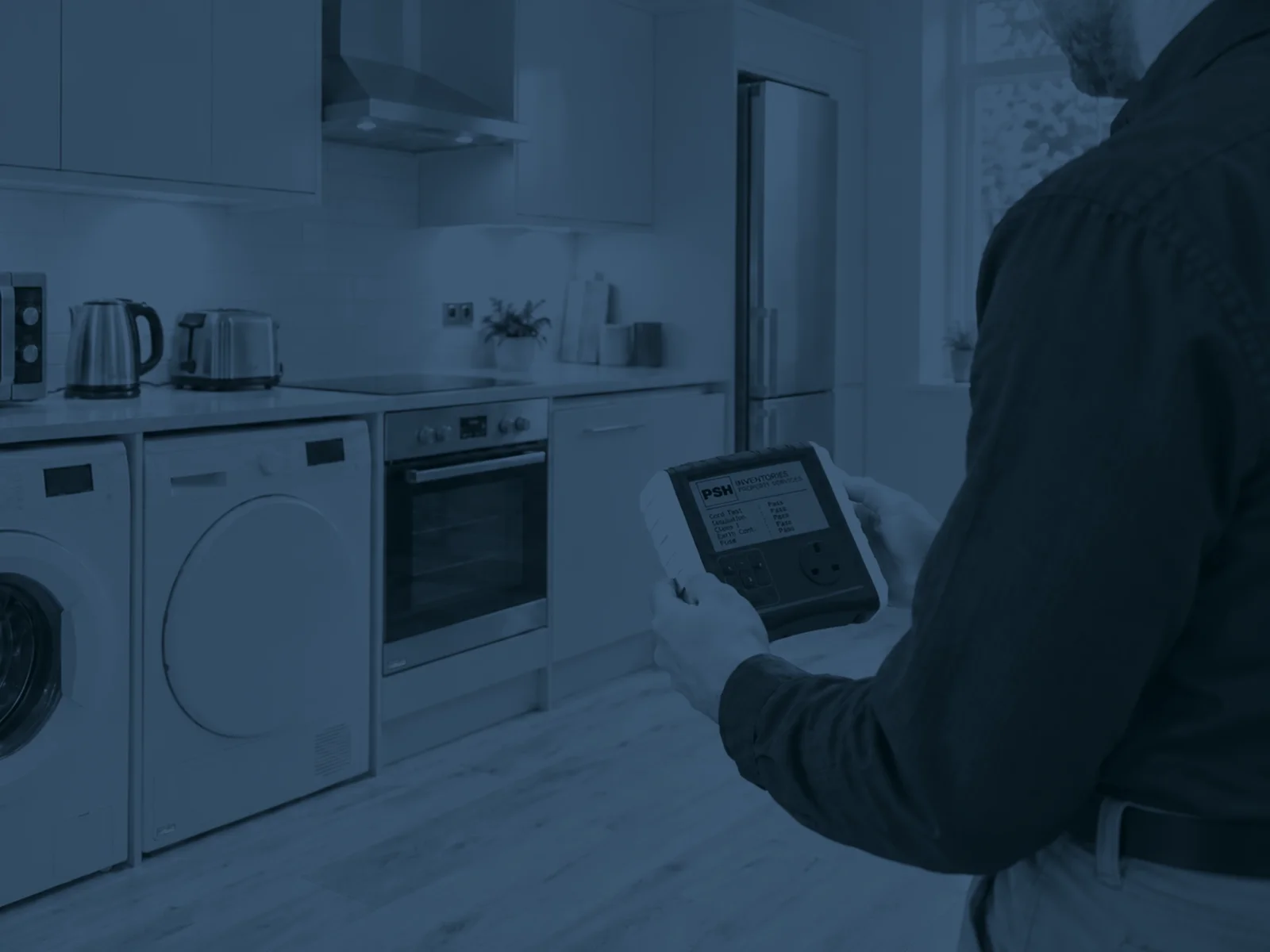 PAT tester in use on kitchen appliances in a rented property